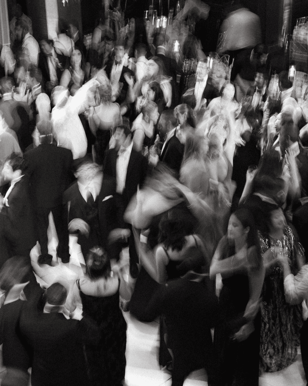 Black and white artistic photo of wedding celebration with people dancing